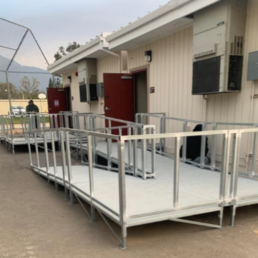 A steel handicap ramp that meets ADA requirements sits on a public school campus in California. 